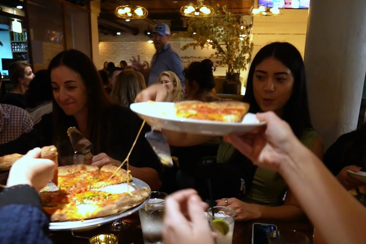 Tour group being served pizza